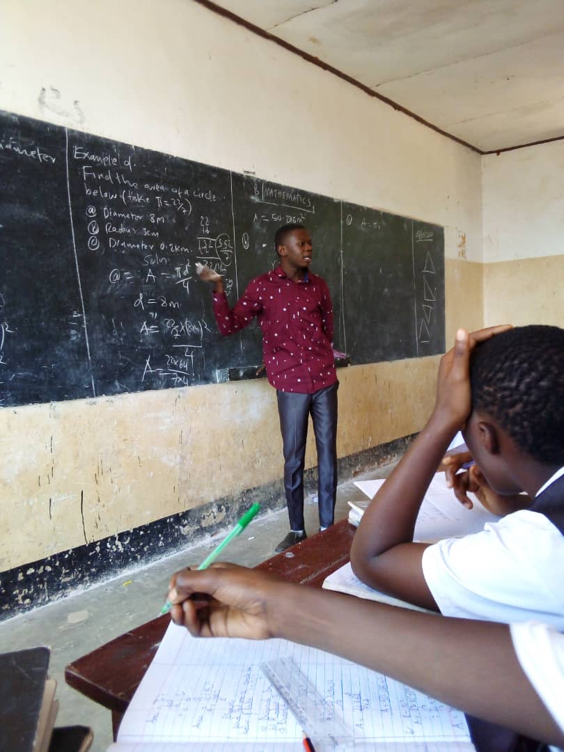 Young man in Tanzania teaches students